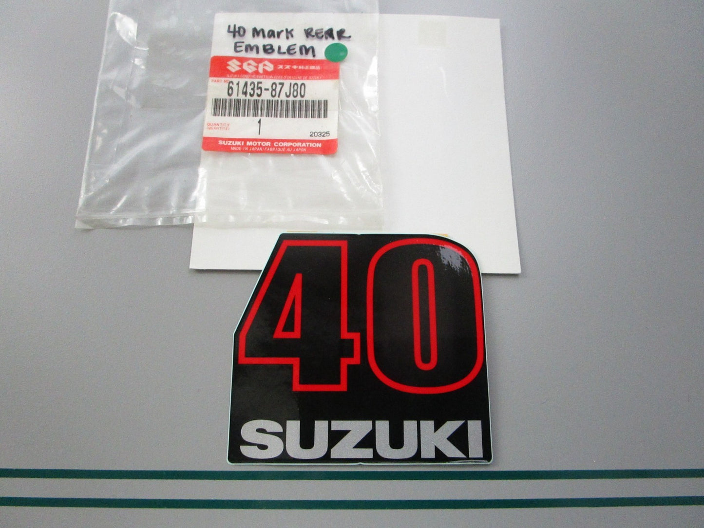 NEW OEM 61435-87J80 Suzuki 40 Mark Rear Emblem 0810