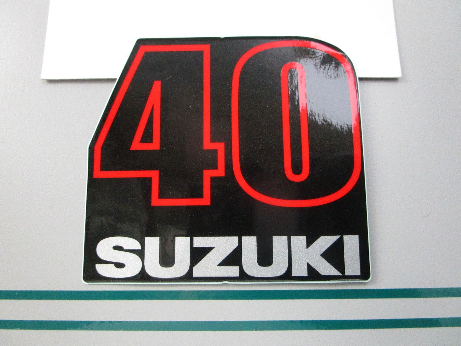 NEW OEM 61435-87J80 Suzuki 40 Mark Rear Emblem 0810