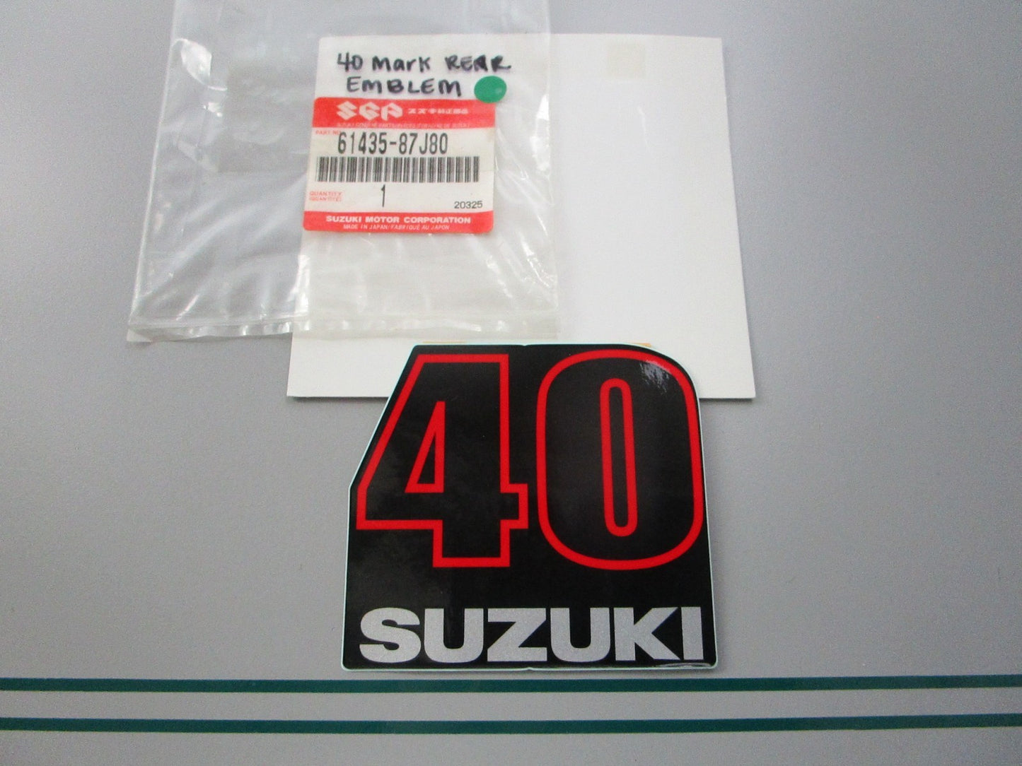NEW OEM 61435-87J80 Suzuki 40 Mark Rear Emblem 0810